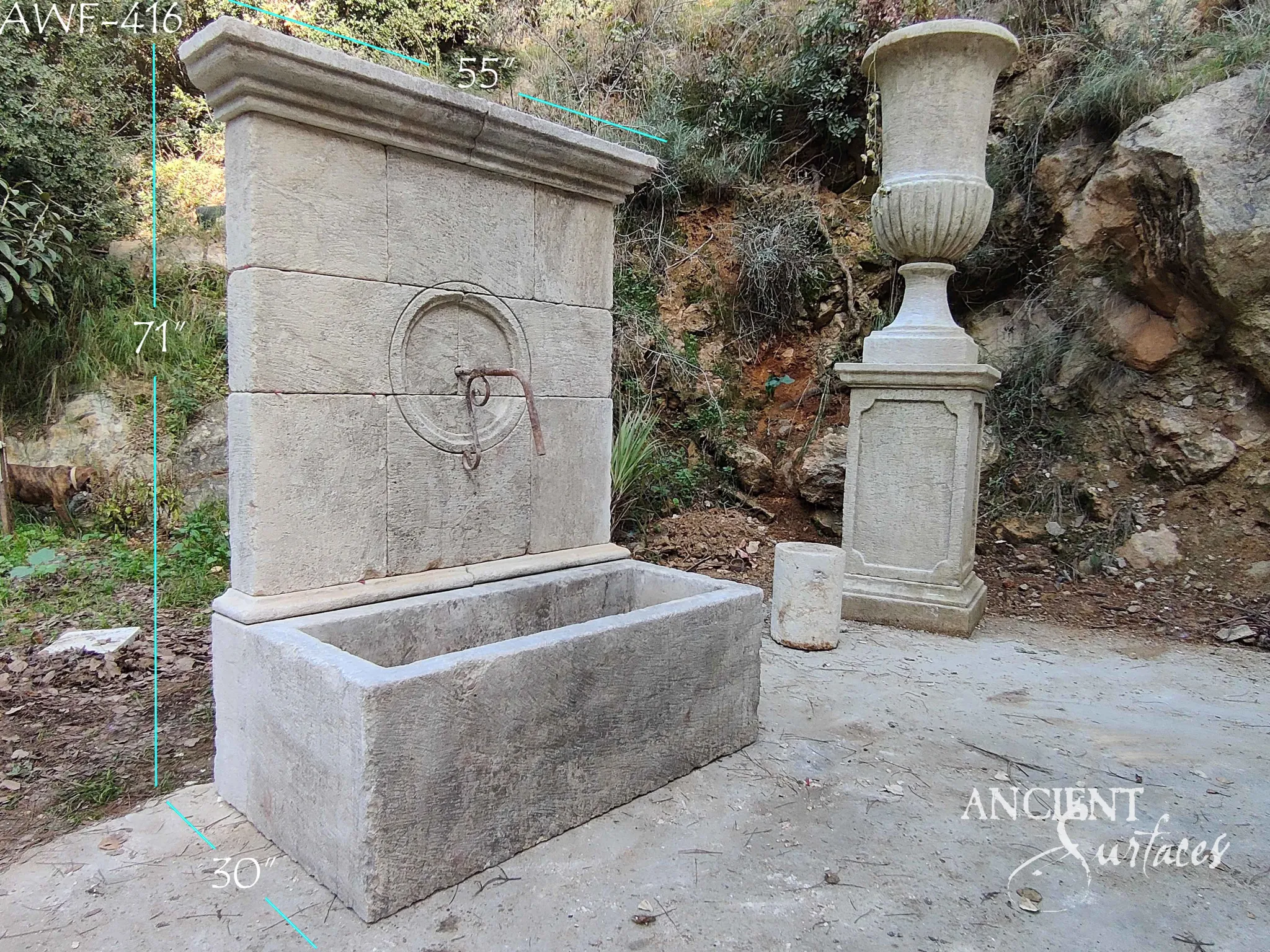 Reclaimed antique limestone wall fountain from Ancient Surfaces catalogued as AWF 416, a plain slab backplate with an iron ring fitting, 71 inches high, photographed outdoors